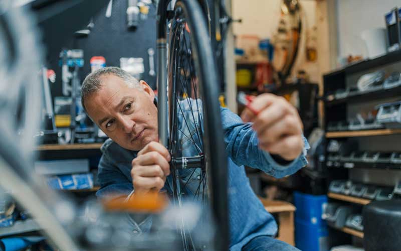 Photo - Person Working in a Bicycle Shop